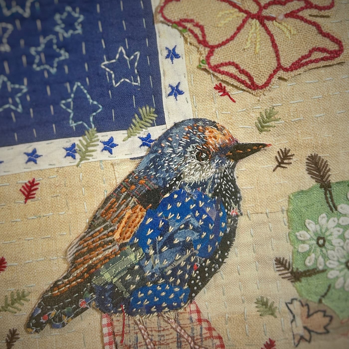 Embroidered bird on fabric patchwork