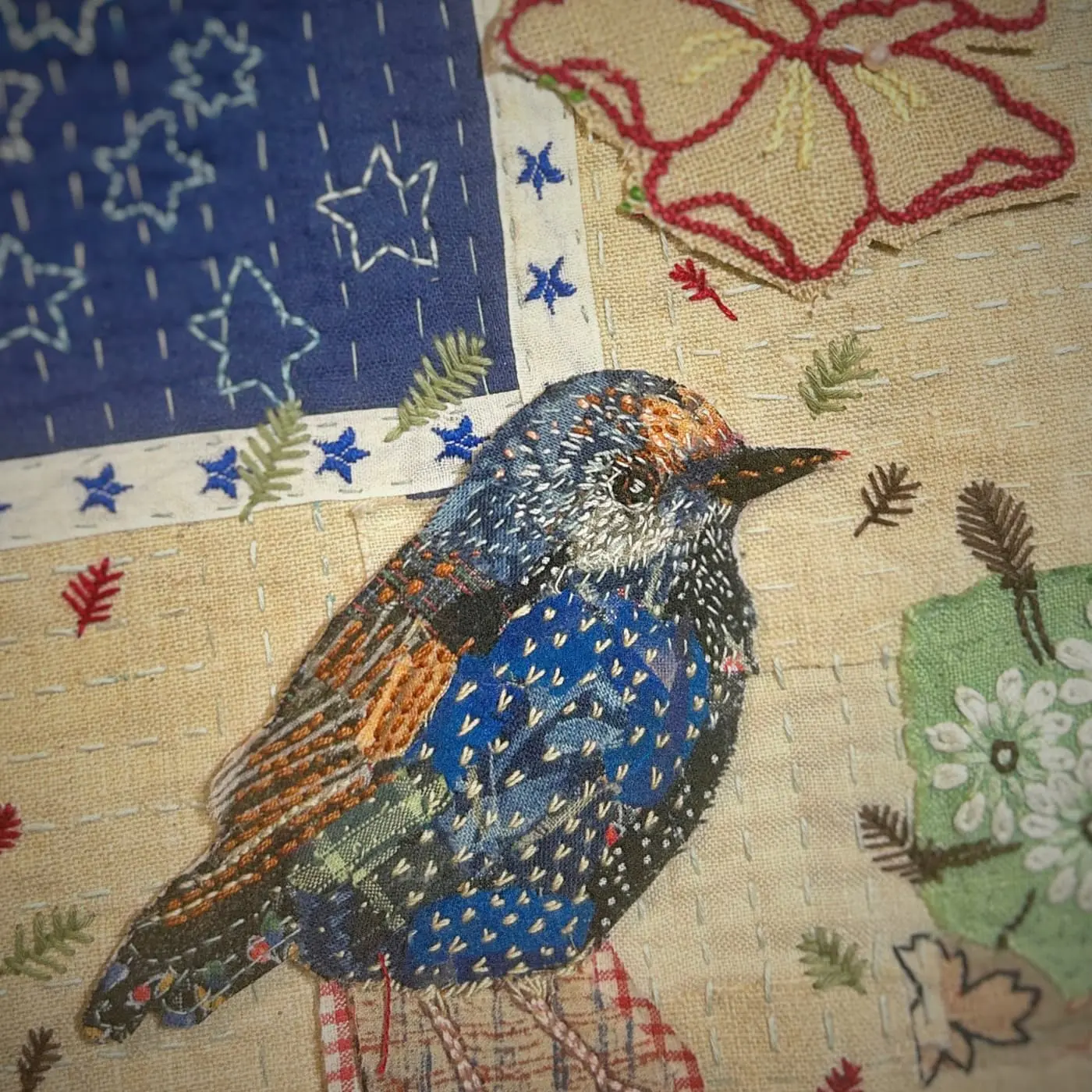 Embroidered bird on fabric patchwork