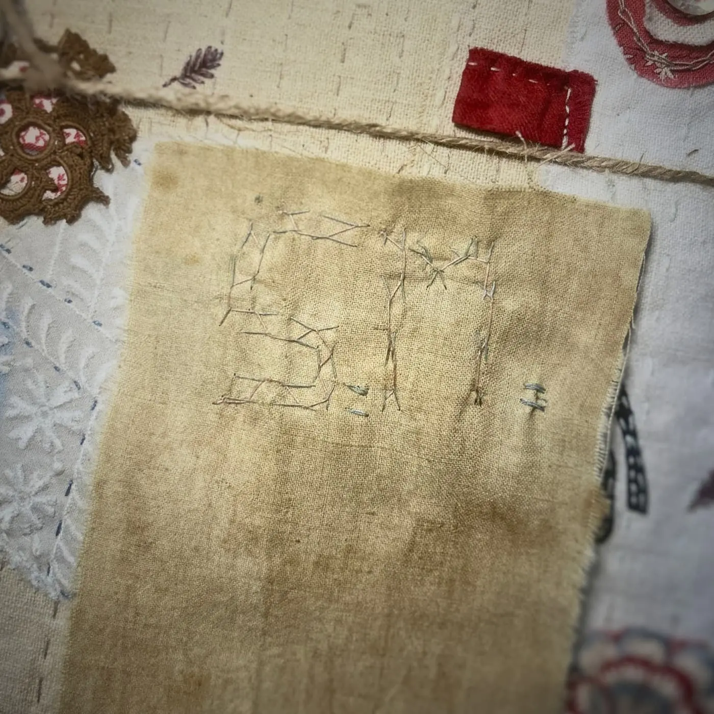 Hand-stitched initials on fabric