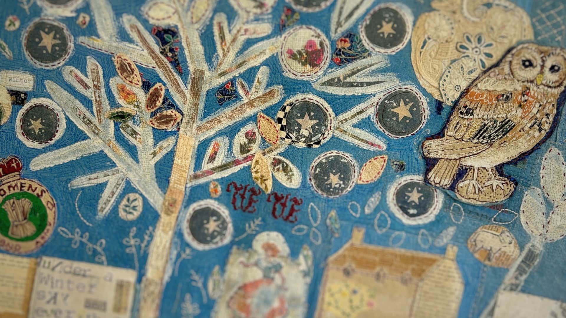 Embroidered tree with owl and stars.