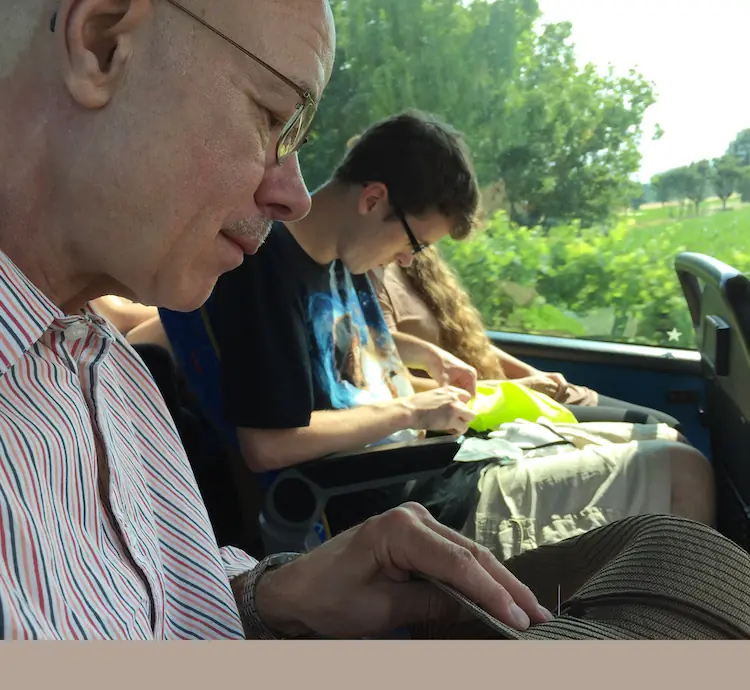 Tom Lundberg and student, mending lesson on a bus in Italy, 2017