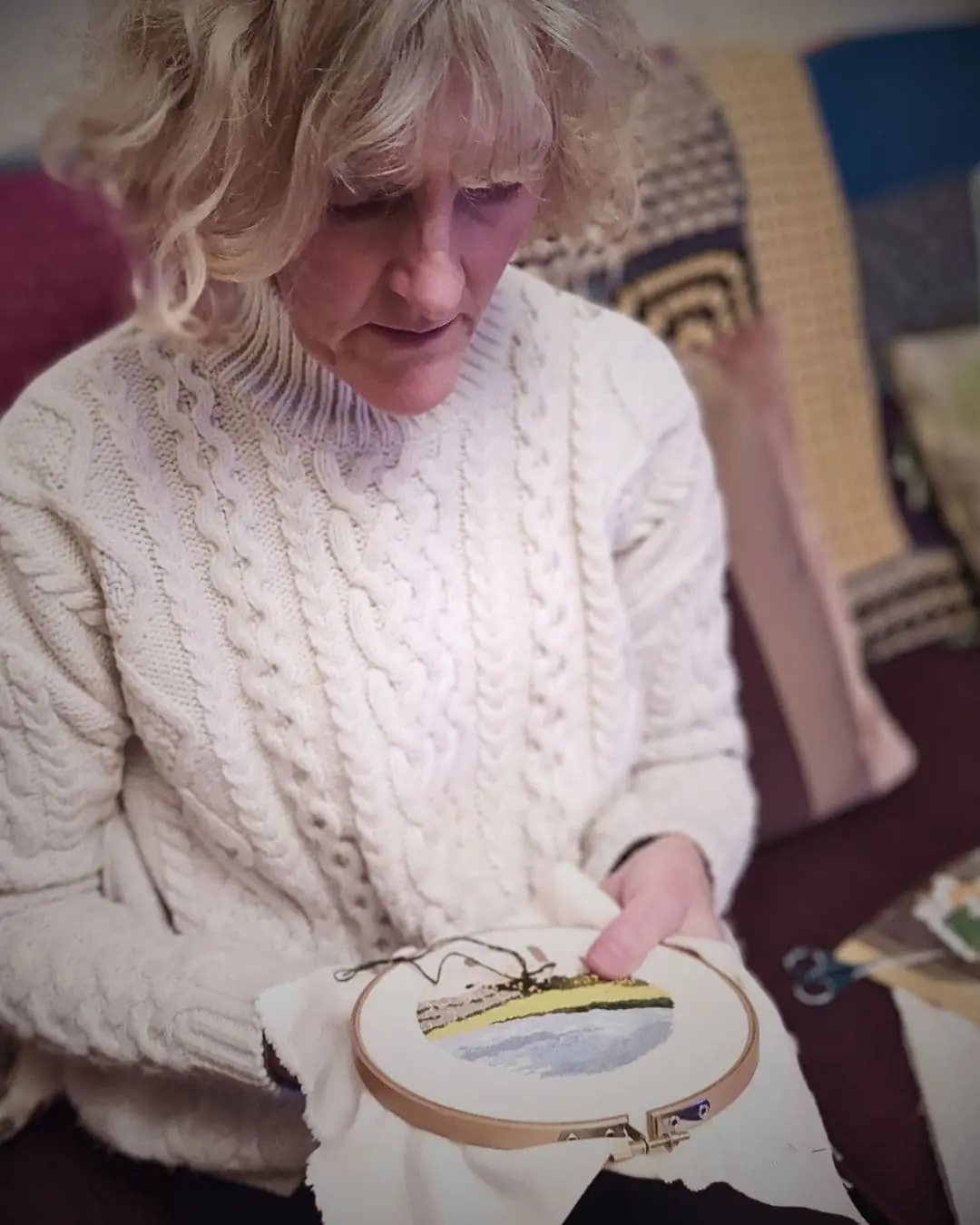 Val Fisher stitching in her home in Newcastle, UK.