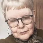 Close-up portrait of textile artist Sue Stone, showcasing her dedication and passion for textile artistry